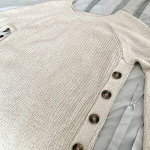Tunic sweater with decorative buttons on both sides